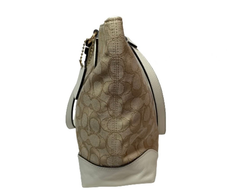 Ditch the typical black bag and grab this gently used Coach Beige Cream Signature Monogram Tote with its roomy interiors it's the perfect everyday bag to carry your essentials and more.